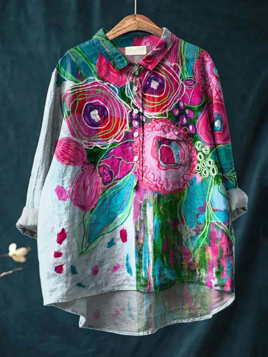 Colorful floral jacket on a hanger against a dark background