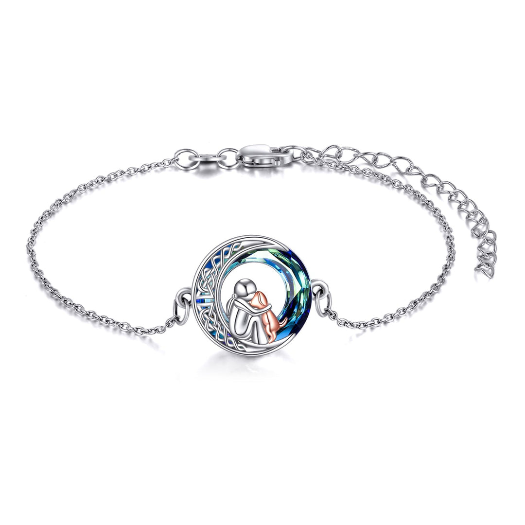 Silver bracelet with a circular charm featuring an angel design on a white background