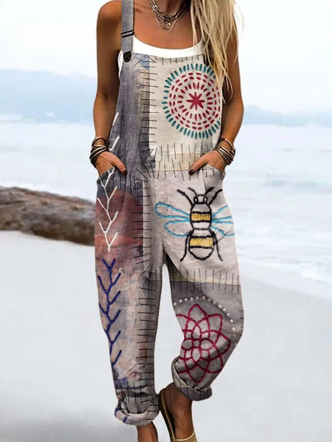Person wearing a colorful patterned jumpsuit with a beach background