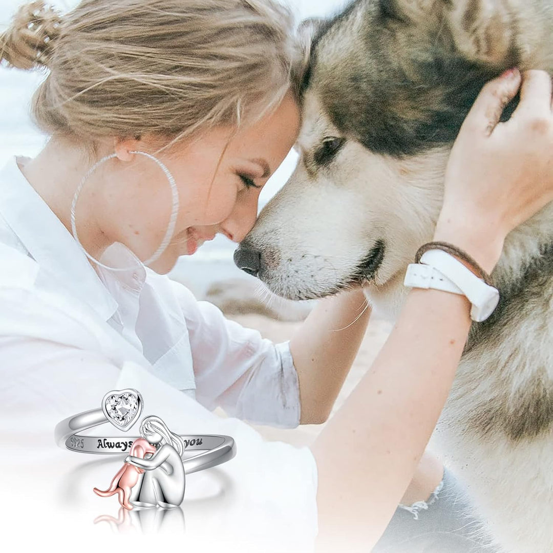 Woman petting a dog with a ring featuring a heart and &
