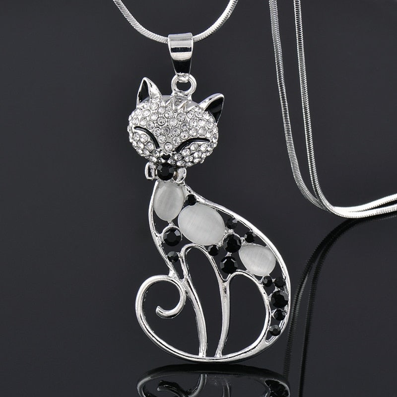 Cat-shaped pendant necklace with rhinestones on a dark background