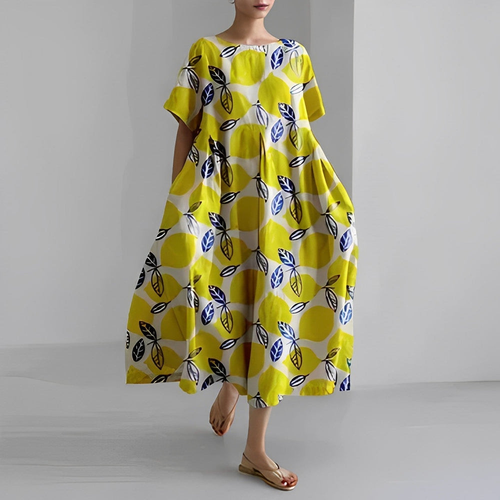 Woman wearing a yellow dress with a pattern on a plain background