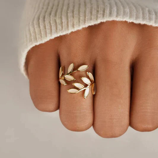 Gold and white leaf-shaped ring on a person&