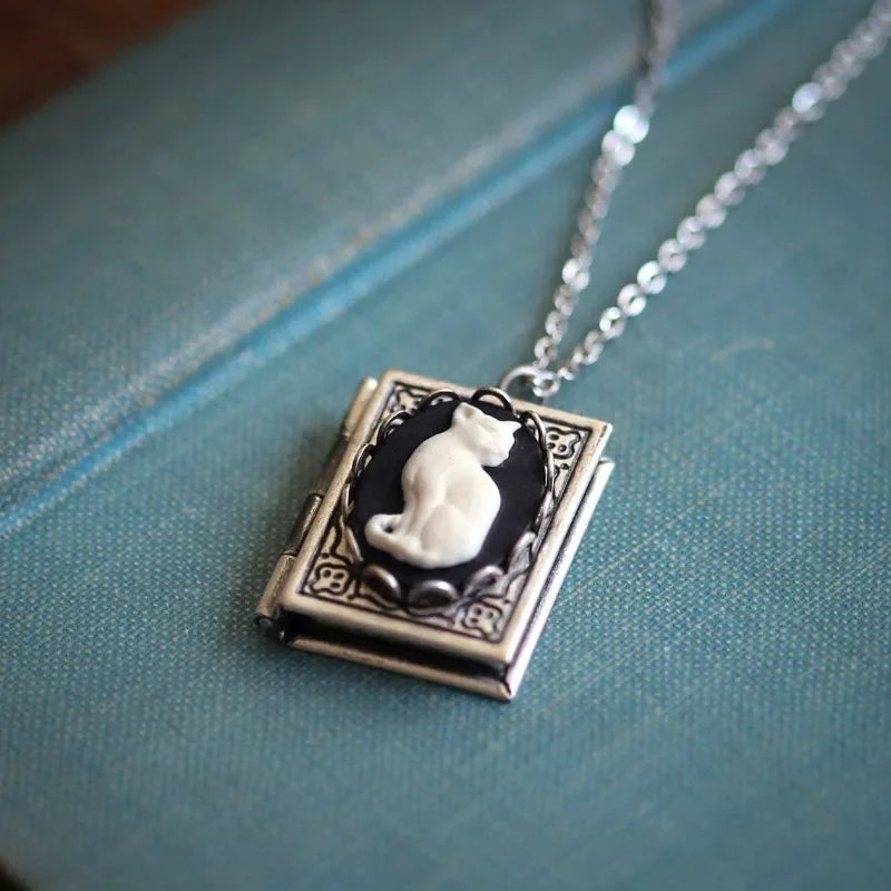 Necklace with a pendant featuring a cat design on a blue fabric background