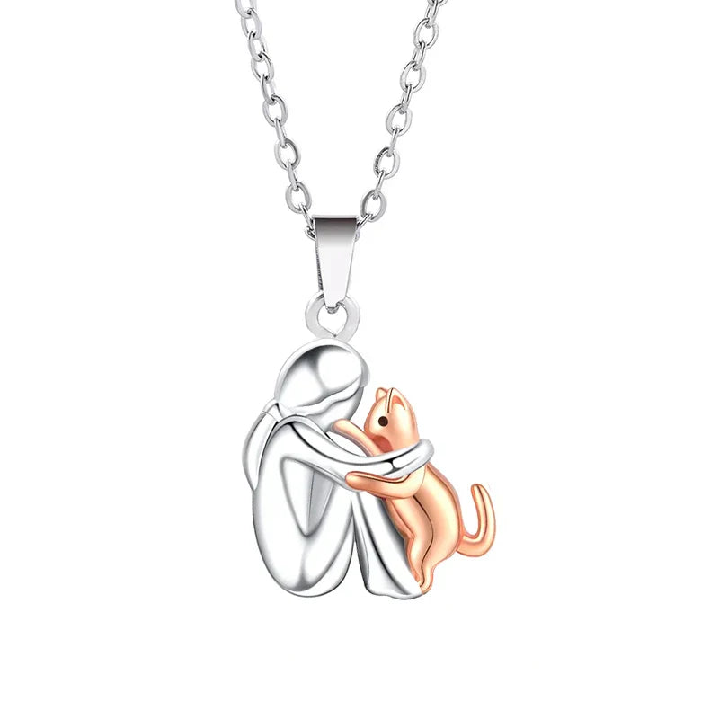 Necklace with a silver pendant featuring a cat and a rose gold cat on a white background