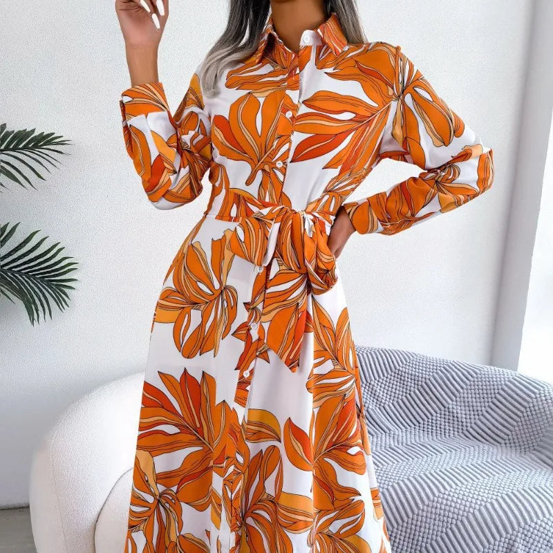 Orange and white floral dress worn by a person, with a neutral background