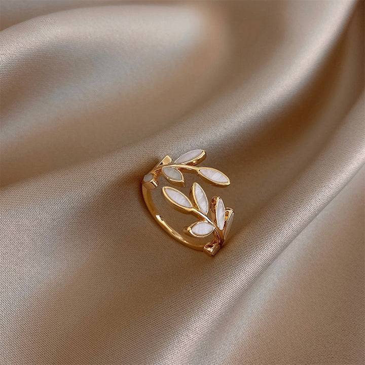 Gold and white earring on beige satin fabric