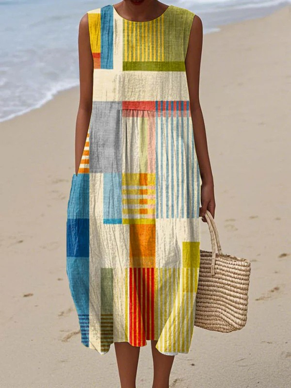 Woman wearing a colorful patterned dress on a beach