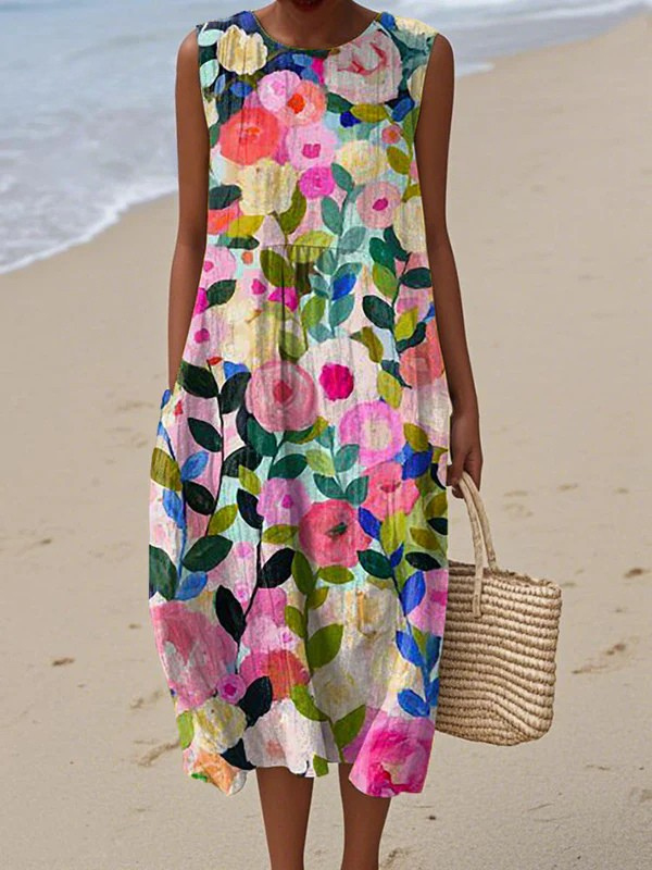 Woman wearing a colorful floral dress on a beach