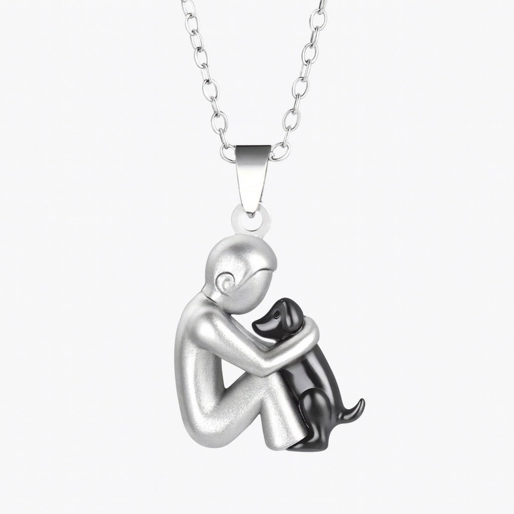 Silver pendant necklace with a figure hugging a black figure on a white background