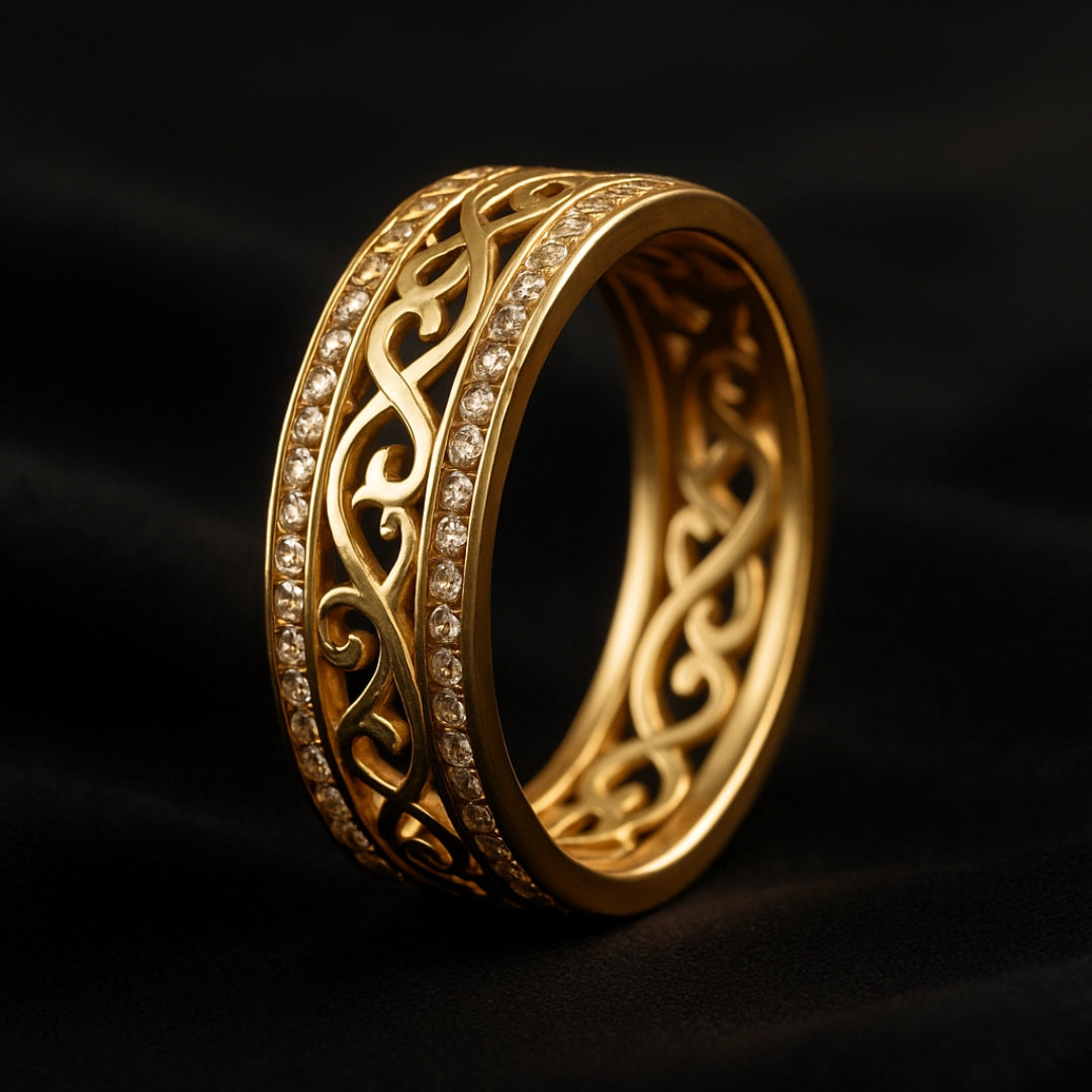 Gold ring with intricate design on a dark background