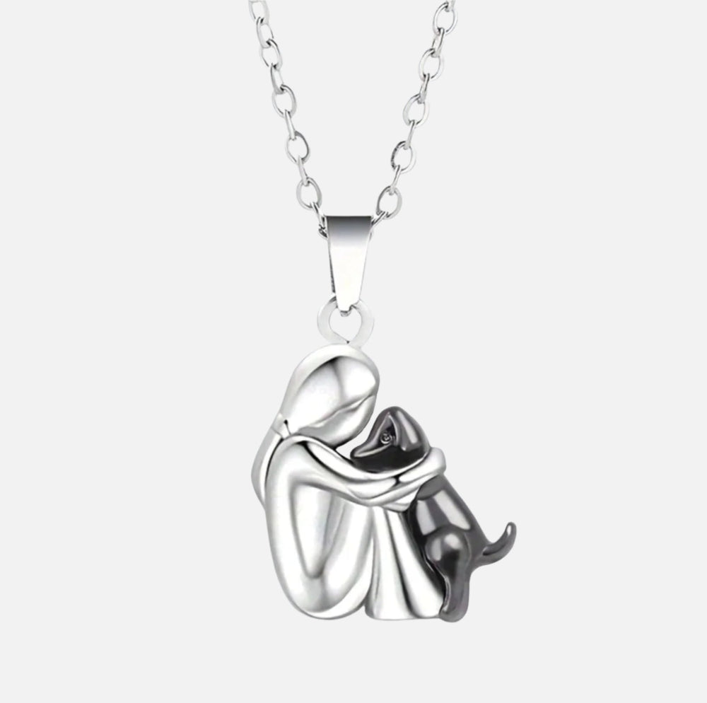 Silver necklace with a pendant of a couple embracing on a white background