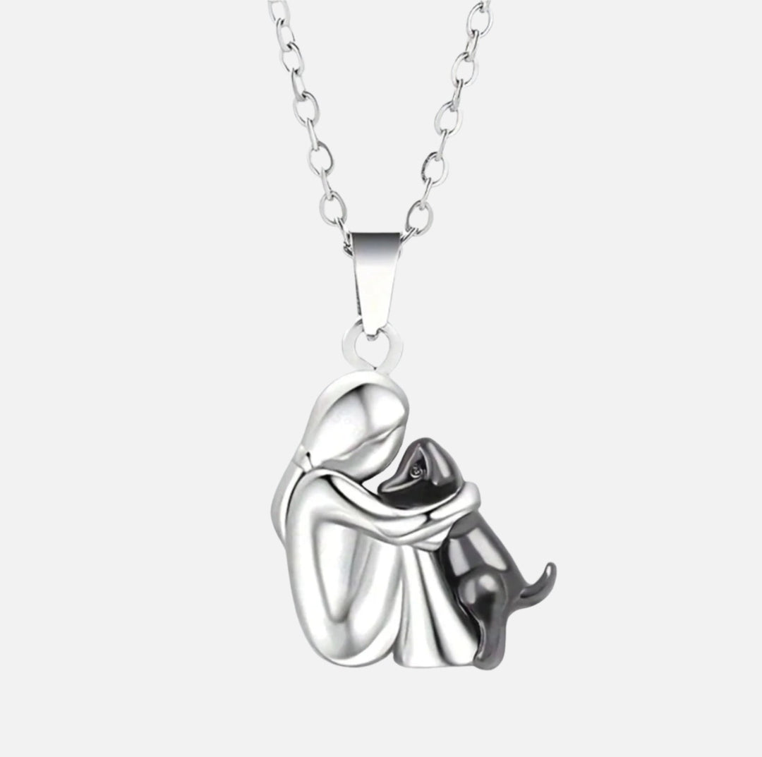 Silver necklace with a pendant of a couple embracing on a white background